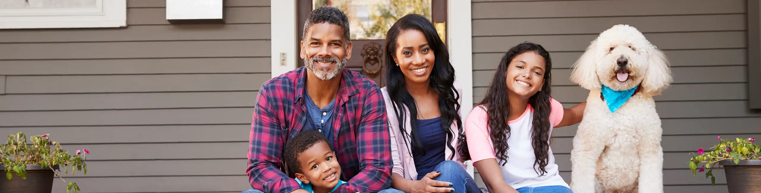 Family sitting on the porch with their dog | Griffin Pest Control Southwest Michigan's most trusted pest control for 90+ years